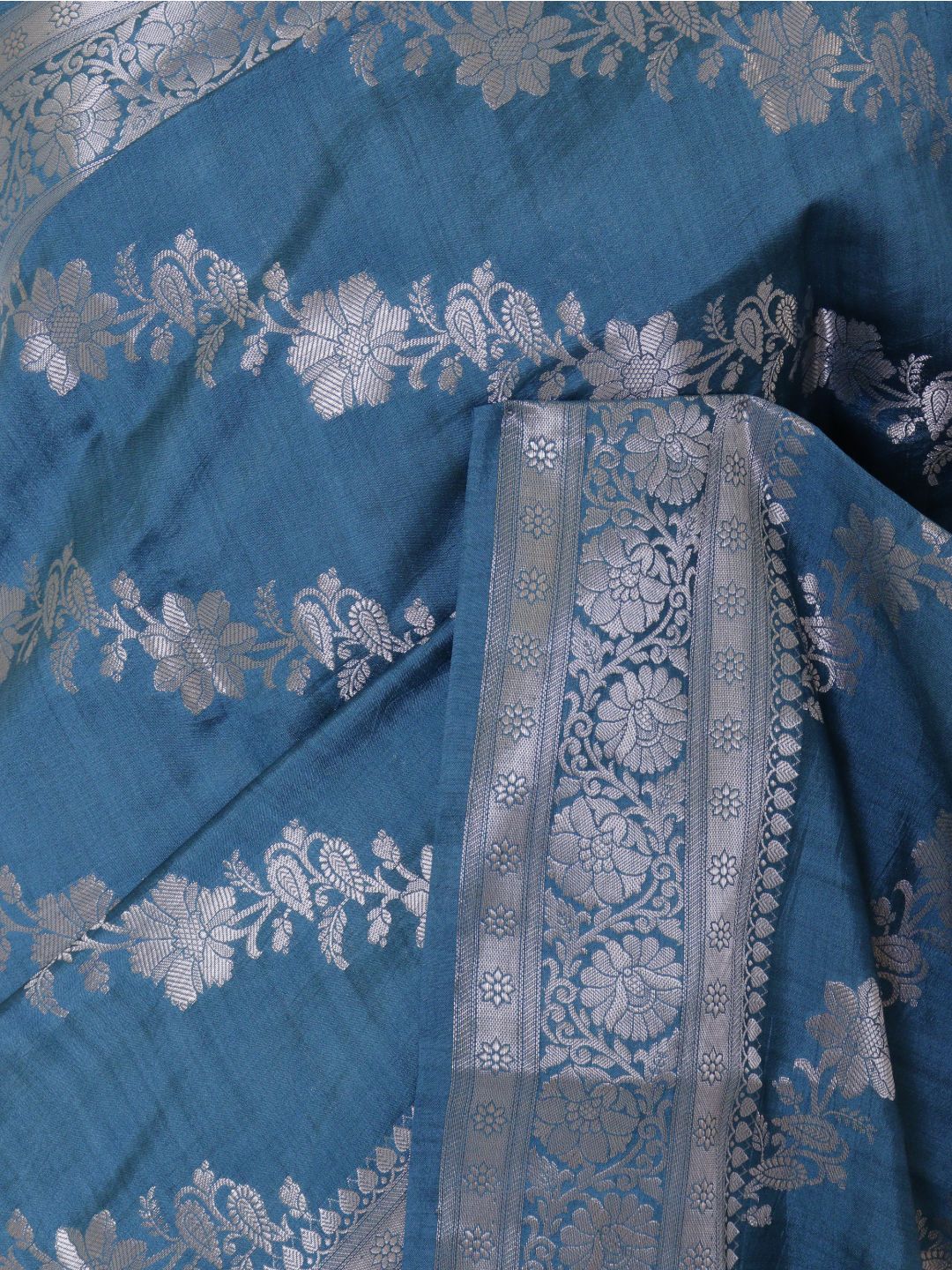 Teal blue with silver-toned detailing Chiniya Silk Banarasi saree border closeup