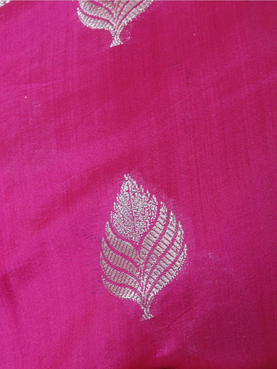 Rani pink with silver-toned detailing Chiniya Silk Banarasi saree border closeup