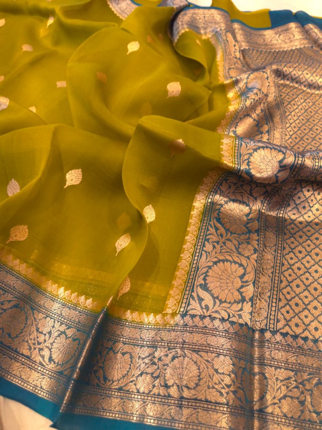 Olive green body with peacock blue border Kora Silk Banarasi saree front drape view