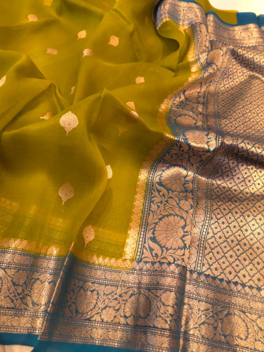 Olive green body with peacock blue border Kora Silk Banarasi saree texture detail
