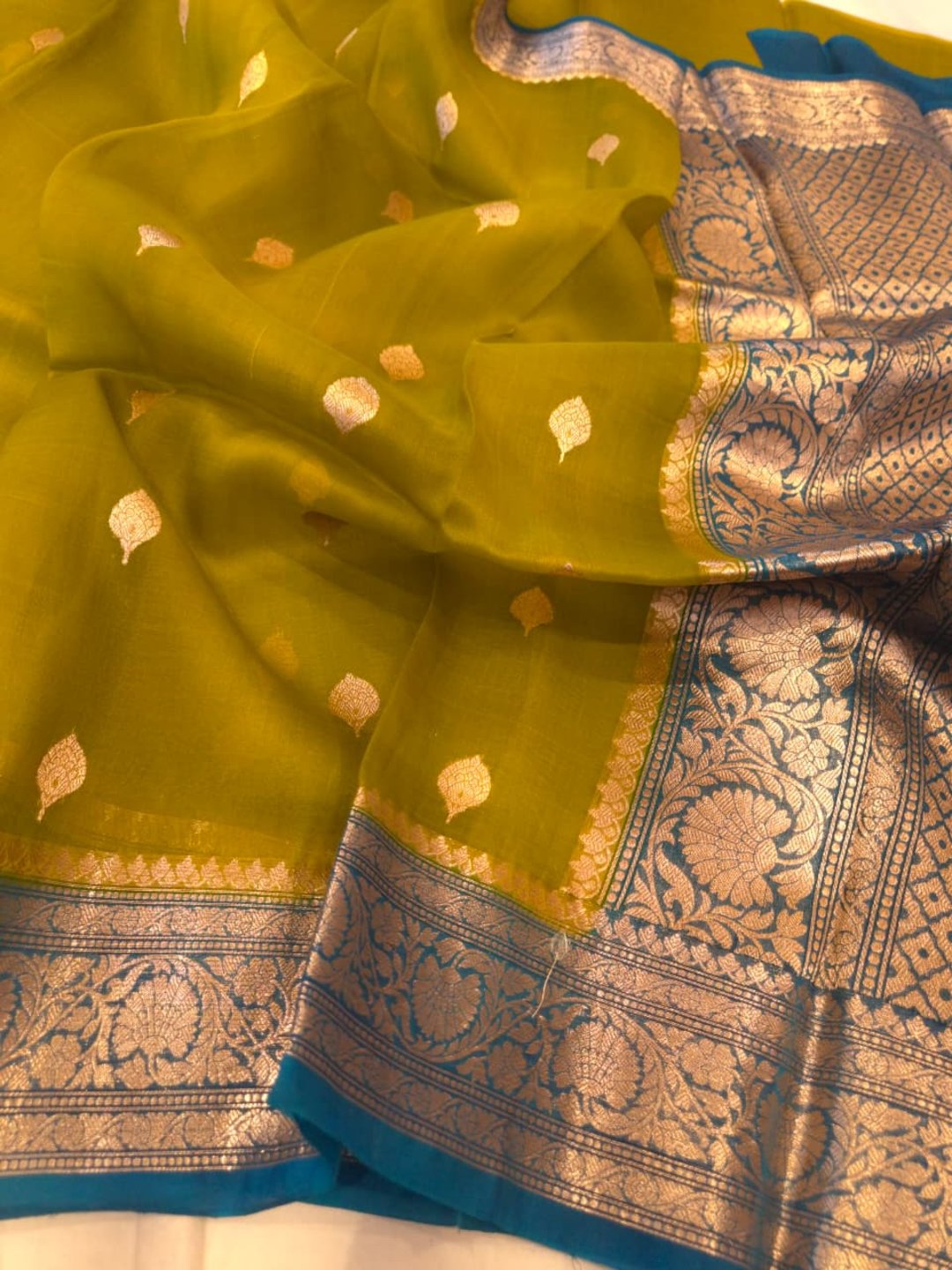 Olive green body with peacock blue border Kora Silk Banarasi saree zari work detail