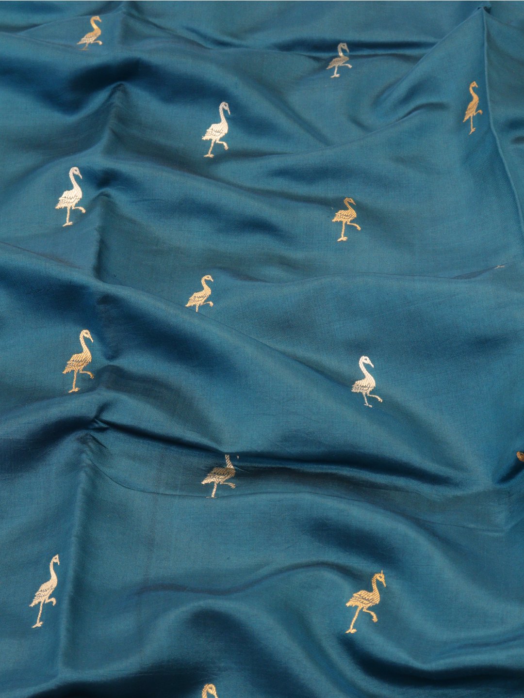 Deep teal blue with gold and silver-toned zari Katan Silk Banarasi saree border closeup