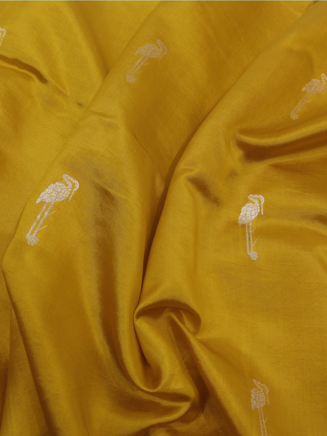 Yellow with gold and silver-toned zari Katan Silk Banarasi saree border closeup