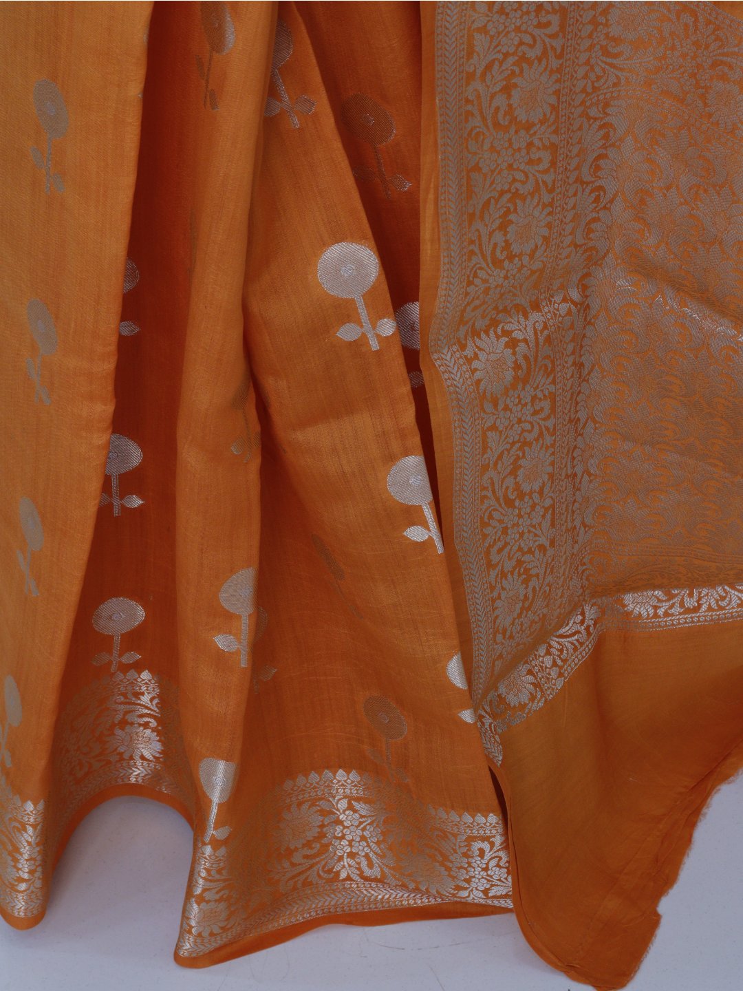 Orange with silver-toned zari detailing Chiniya Silk Banarasi saree folded view