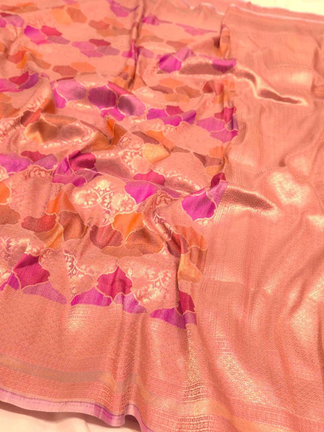 A soft peach and rose-gold base with pink, purple, orange and muted brown accents Mulbari silk Banarasi saree front drape view