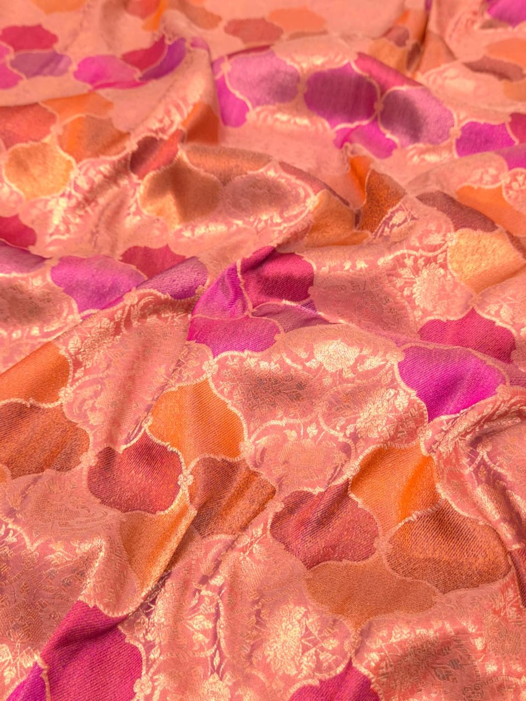 A soft peach and rose-gold base with pink, purple, orange and muted brown accents Mulbari silk Banarasi saree pallu detail