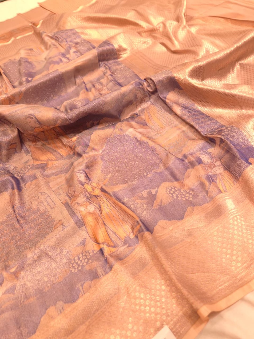 A muted lavender-grey base with peach, orange and gold-toned Mulbari Silk Banarasi saree zari work detail