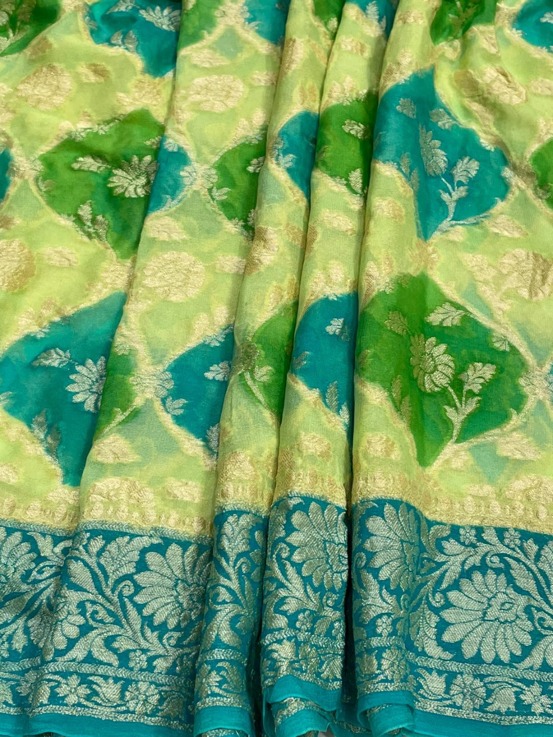 vibrant mix of light green and aqua blue. Chiffon Banarasi saree pallu detail